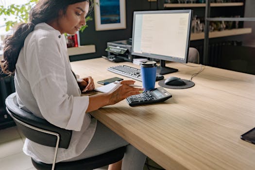 a person using a planner with a cup of coffee